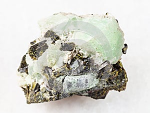 Epidote crystals on prehnite stone on white