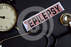 Epilepsy on the print paper with Healthcare Concept Inspiration. alarm clock, Black stethoscope.