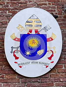Episcopal emblem hanging on the wall of the episcopal palace of San Miniato