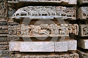 Episode from Mahabharata, Carved on the Friezes at the base of temple. Kedareshwara temple, Halebidu, Karnataka photo
