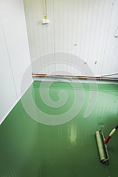 Epoxy and waxed green floor newly applied in the industrial hall