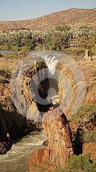 Epupa Falls Waterfall with Baobab trees at the border of Namibia and Angola in Kaokoland, Southern Africa. photo