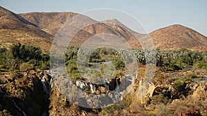 Epupa Falls Waterfall with Baobab trees at the border of Namibia and Angola in Kaokoland, Southern Africa. photo