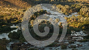 Epupa Falls Waterfall bush landscape on the border of Angola and Namibia, in the Kaokoland area of the Kunene Region. photo