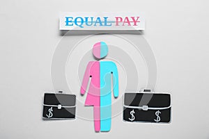 Equal pay concept. Human paper figure as male and female halves against light grey background, flat lay