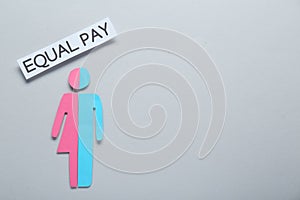 Equal pay concept. Human paper figure as male and female halves against light grey background, flat lay with space for text