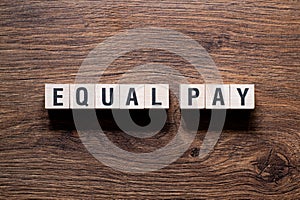 Equal pay - word concept on building blocks, text