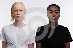 Equal women with different appearance standing near each other