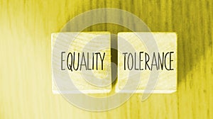 Equality tolerance words written on wood blocks. Equal rights inclusion social and business concept photo