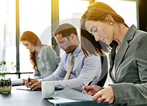 Equally contributing to the success of their project. a team of executives having a formal meeting in a boardroom.