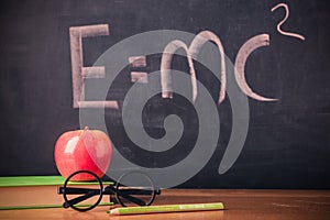 Equation E=mc2 handwritten on blackboard