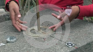 Equator line stone landmark with indicators of compass North South West East.