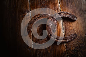 Equesrtian background. Lucky old  horseshoes laying at wooden background