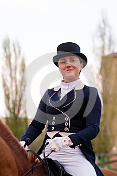 Equestrian in dressage attire on chestnut horse