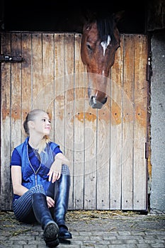 Equestrian girl and horse in stable