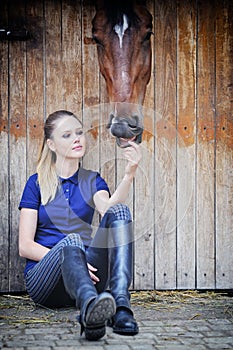 Equestrian girl and horse in stable photo