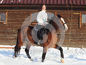 Equestrian girl ride her horse at winter morning