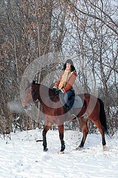 Equestrian girl in winter woods