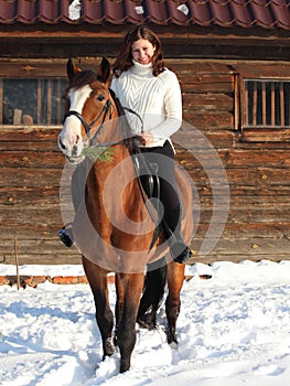 Equestrian girl ride her horse at winter morning
