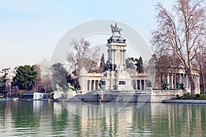 Equestrian monument to Alfonso XII reflected in pond photo