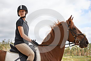 Equestrian, riding and woman on horse in nature on adventure and journey in countryside. Ranch, animal and rider outdoor