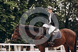 Equestrian sport - a young girl is riding a horse