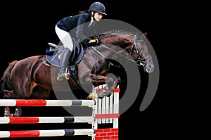 Equestrianism: Young girl in jumping show, isolated on black
