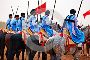 Equestrians participating in a traditional fancy event named Tbourida dressed in a traditional Moroccan outfit