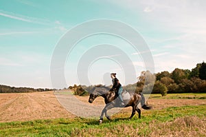 Equestrienne rides on the hillside.