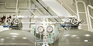 Equipment, cables, pipes and valves in engine room of a ship pow