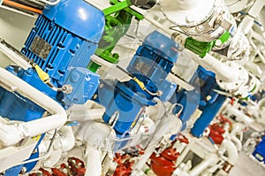 Equipment, cables, pipes and valves in engine room of a ship pow