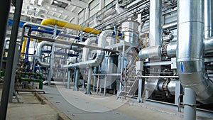 Equipment, cables and piping as found inside of industrial power plant. Scene. Inside a huge gas industry plant