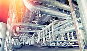 Equipment, cables and piping as found inside of a modern industrial power plant