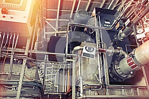 Equipment, cables and piping as found inside of a modern industrial power plant