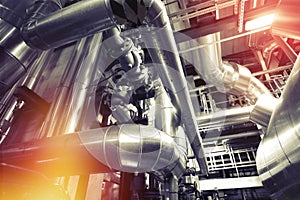 Equipment, cables and piping as found inside of a modern industrial power plant