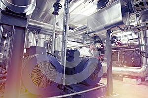 Equipment, cables and piping as found inside of a modern industrial power plant