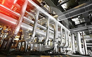 Equipment, cables and piping as found inside of a modern industrial power plant. Industrial zone, Steel pipelines, valves, cables