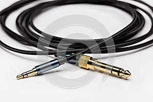 Equipment for connecting devices. Golden plug, connector, close-up, light background.