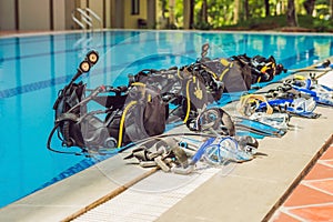 Equipment for diving is on the edge of the pool, ready for a les