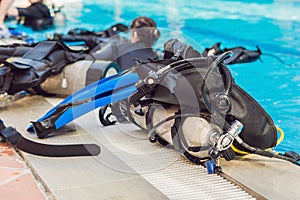 Equipment for diving is on the edge of the pool, ready for a les