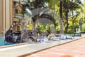 Equipment for diving is on the edge of the pool, ready for a lesson