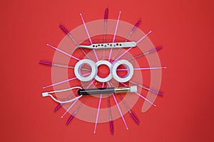 Equipment for eyelash extensions on a red background.