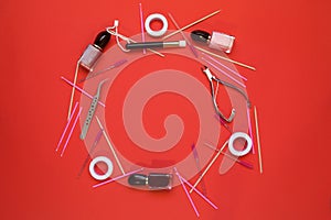 Equipment for eyelash extensions on a red background.