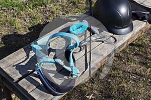 Equipment for horse care and riding on a wooden bench