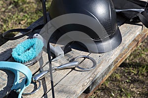 Equipment for horse care and riding on a wooden bench