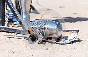 Equipment knight - the participant in the knight festival - shield, sword, helmet and glove lie on the ground near the lists