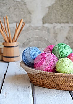 The equipment for knitting and crochet hook, colorful rainbow cotton yarn, ball of threads, wool. Handmade crocheting crafts. DIY