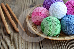 The equipment for knitting and crochet hook, colorful rainbow cotton yarn, ball of threads, wool. Handmade crocheting crafts. DIY