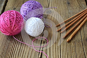 The equipment for knitting and crochet hook, colorful rainbow cotton yarn, ball of threads, wool. Handmade crocheting crafts. DIY