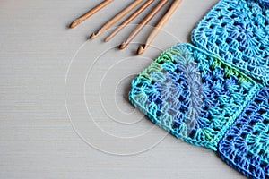 Equipment for knitting and crochet hook, colorful rainbow cotton yarn, ball of threads, wool, knitted elements, napkin . Granny